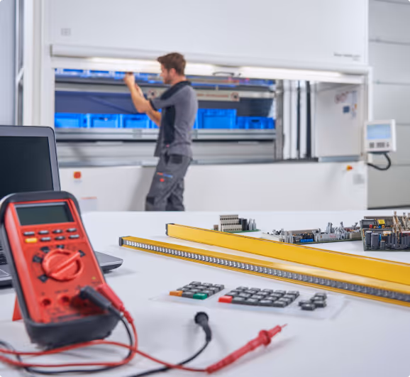 Professional maintenance technician working on Hänel storage system with diagnostic equipment