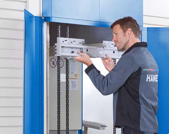 Hänel service engineer working on storage system with genuine parts and diagnostic equipment
